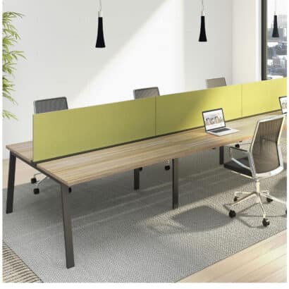 A modern office workspace featuring modular benching from Deskmakers. The benching system offers a variety of workstation options, including single-user, two-user, and four-user configurations. It can be customized with a variety of features, such as privacy panels, storage units, and power outlets. Made with high-quality materials and backed by a five-year warranty, this benching system is a durable and versatile solution for any office environment.