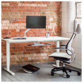 A Humanscale Float height-adjustable standing desk, designed to promote movement and improve health at work.