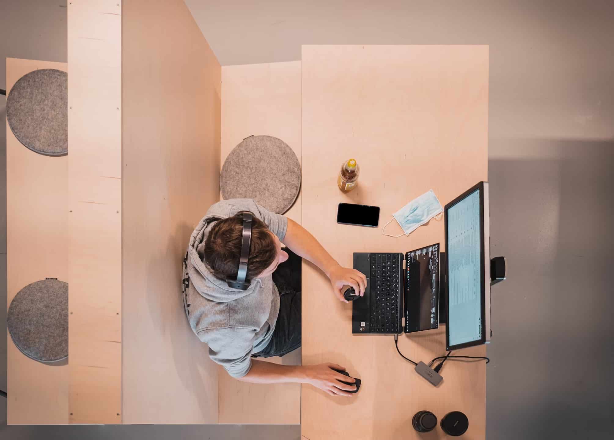 A woman in an office working on a laptop